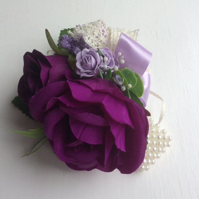a wrist corsage featuring artificial flowers
