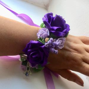 a circlet of purple and lilac flowers for the wrist