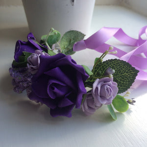 a half circlet of Purple and lilac roses