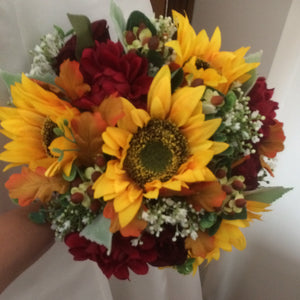 A brides wedding bouquet featuring dahlia, roses & sunflowers