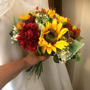 A brides wedding bouquet featuring dahlia, roses & sunflowers