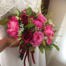 A brides bouquet of deep pink and burgundy silk roses & peonies