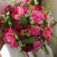 A brides bouquet of deep pink and burgundy silk roses & peonies