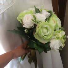 A wedding bouquet of green and white artificial silk roses