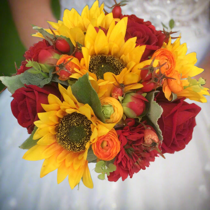 a brides wedding bouquet featuring artificial silk roses & sunflowers