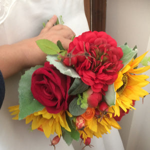 a brides wedding bouquet featuring artificial silk roses & sunflowers