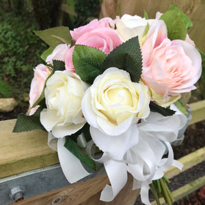 A wedding bouquet of artificial silk dusky pink and blush roses