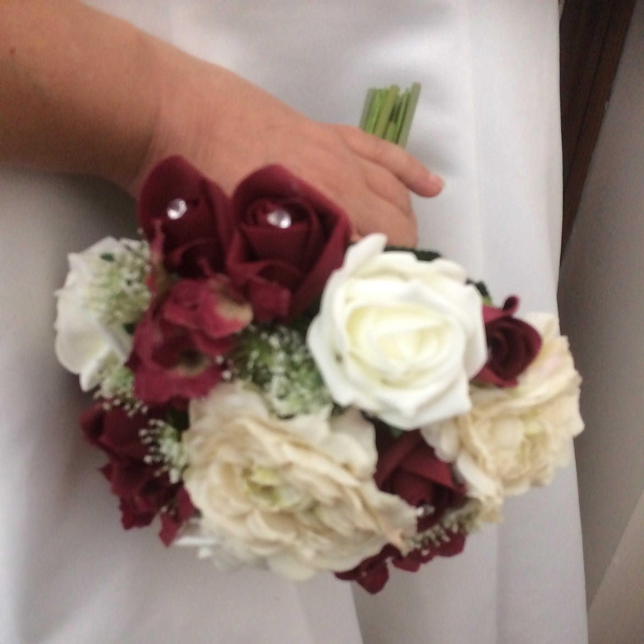 a wedding bouquet of cream, ivory & burgundy roses & hydrangea