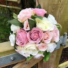 A wedding bouquet of artificial silk dusky pink and blush roses