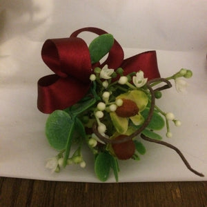 A buttonhole featuring a hypericium berries and gypsophila