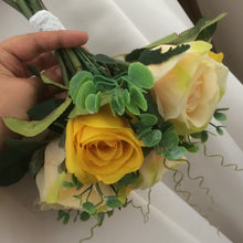 A wedding bouquet of yellow and champagne silk roses