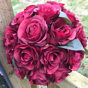 A wedding bouquet of artificial silk burgundy rose flowers