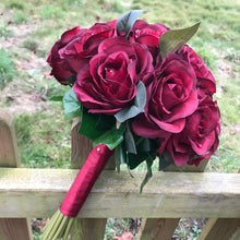 A wedding bouquet of artificial silk burgundy rose flowers