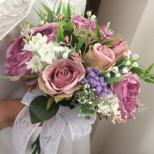 A bouquet collection of ivory dusky pink and mauve artificial silk flowers