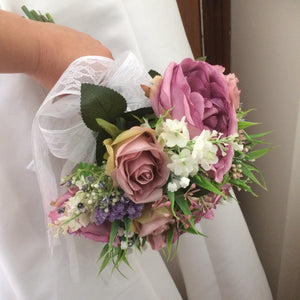 A bouquet collection of ivory dusky pink and mauve artificial silk flowers