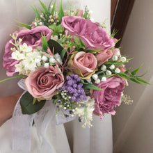 wedding bouquet of dusky pink and mauve artificial flowers