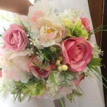 A bridal bouquet of artificial silk pink silk rose peony and berries