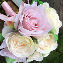 a wedding bouquet of pale pink and cream silk rose flowers