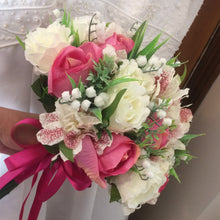 a wedding bouquet of artificial roses, astromeria & lily of the valley