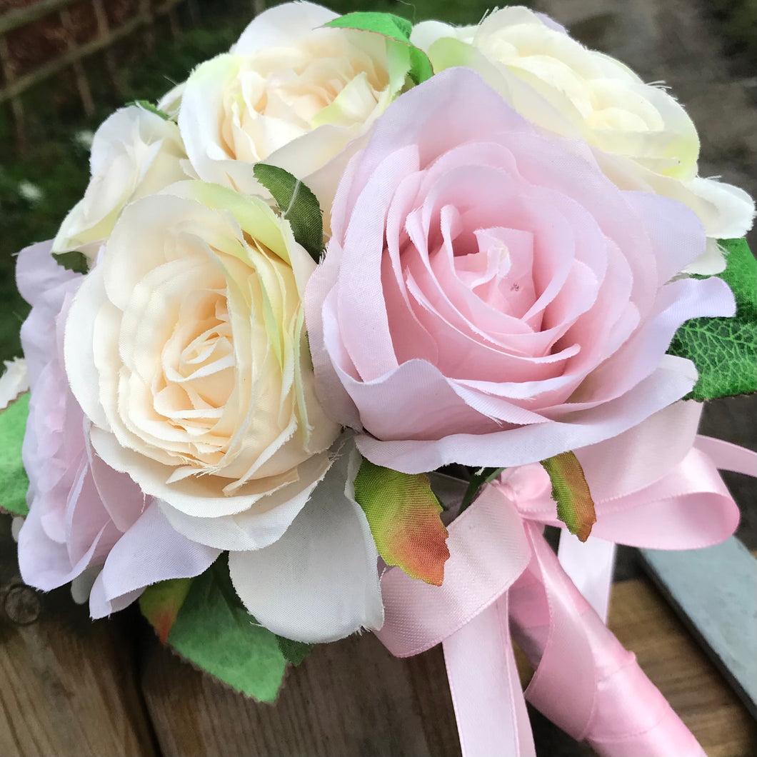 wedding bouquet featuring pale pink and cream roses