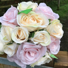 a wedding bouquet of pale pink and cream silk rose flowers