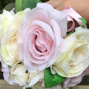a wedding bouquet of pale pink and cream silk rose flowers