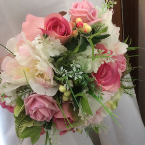 A bridal bouquet of artificial silk pink silk rose peony and berries