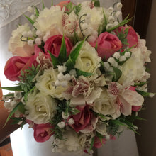a wedding bouquet of artificial roses, astromeria & lily of the valley