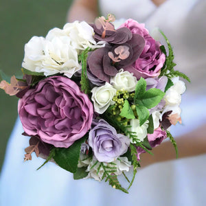 A wedding bouquet for the bride of pink & lilac peony and ranunculus
