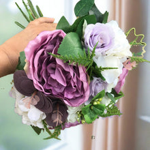 A wedding bouquet for the bride of pink & lilac peony and ranunculus