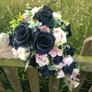 A teardrop bouquet of artificial navy and blush roses