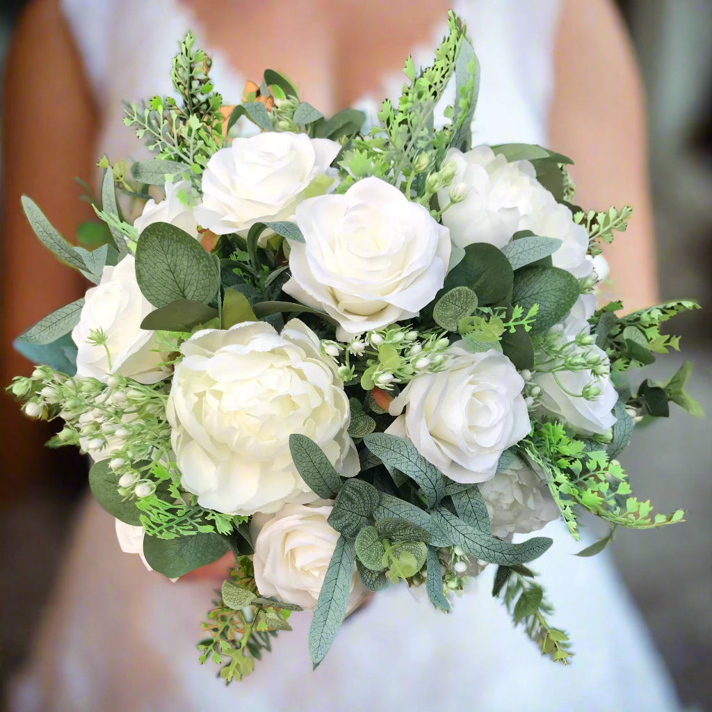 a large wedding bouquet of artificial faux silk white roses and peonies