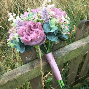 a wedding bouquet collection of pink and mauve flowers