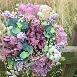 a wedding bouquet collection of pink and mauve flowers