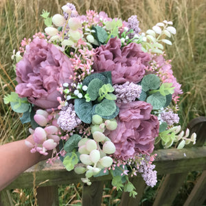 a wedding bouquet collection of pink and mauve flowers