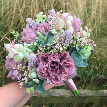 a wedding bouquet collection of pink and mauve flowers