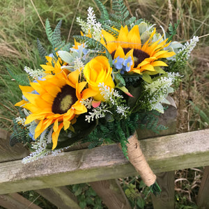 a brides bouquet of sunflowers roses and blue forget-me-nots