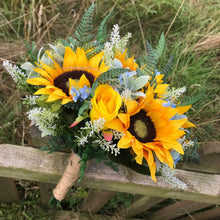 a brides bouquet of sunflowers roses and blue forget-me-nots