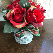 red frosted roses arranged in a metal bucket with tartan ribbon and wooden star