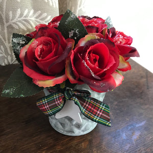 frosted red roses arranged in metal bucket