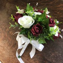 A collection of wedding bouquets featuring ivory and burgundy roses