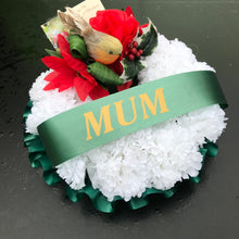 A christmas memorial based posy wreath of red roses and carnations