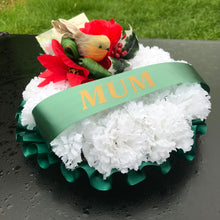 A christmas memorial based posy wreath of red roses, poinsettia & a robin