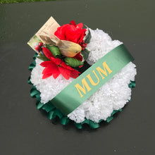 A christmas memorial based posy wreath of red roses, poinsettia & a robin