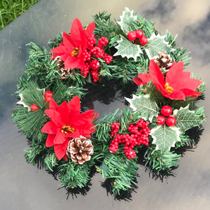 christmas pine wreath with poinsettia cones  and holly