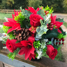 A Christmas memorial flower graveside arrangement