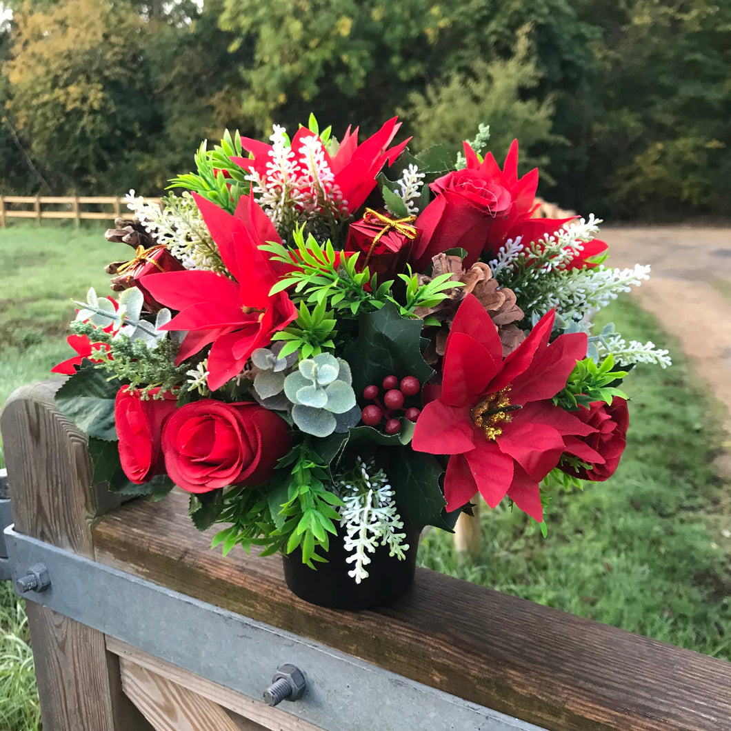 A Christmas memorial flower graveside arrangement