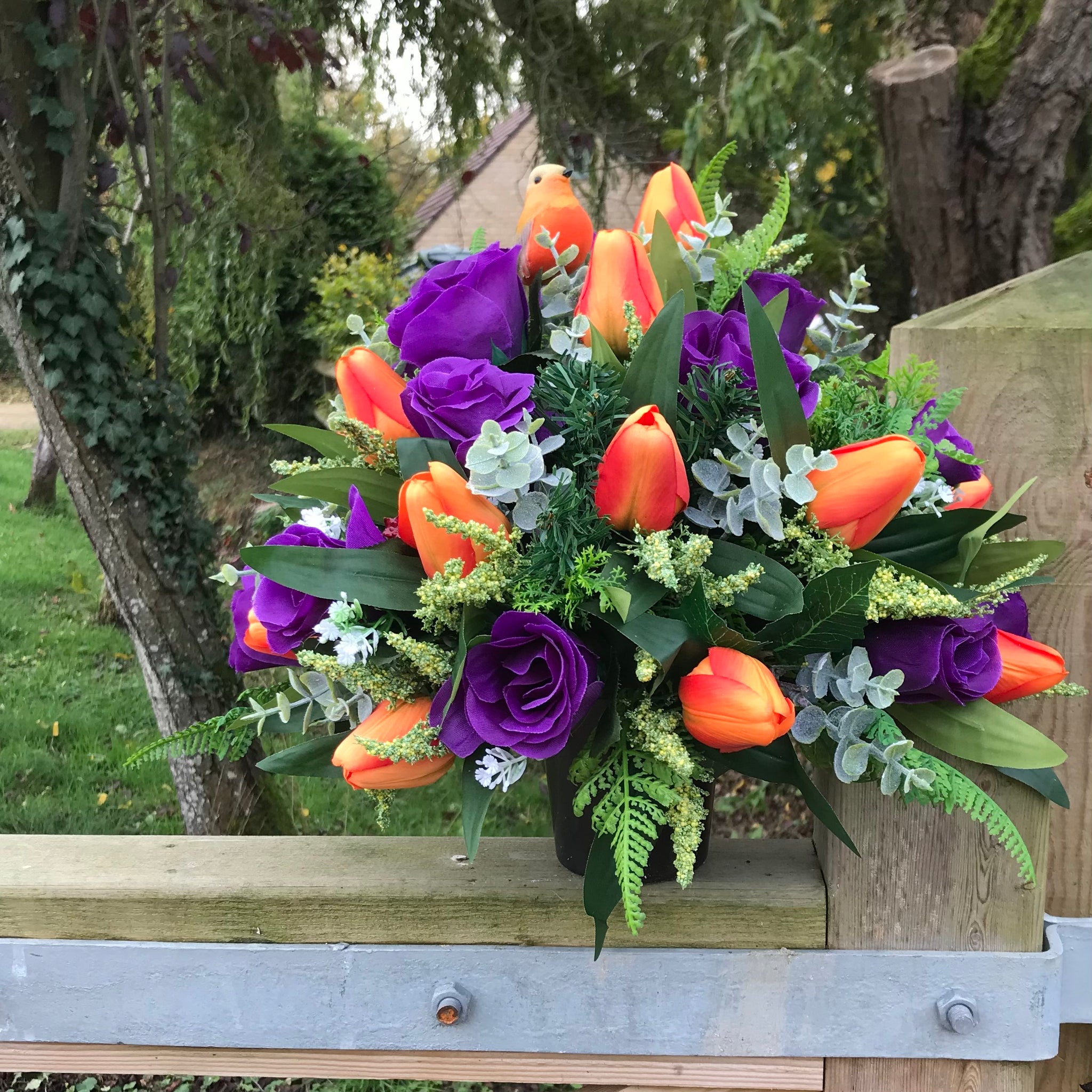 a silk flat back graveside flower arrangement in black pot AbigailRose