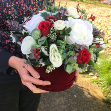 A Christmas artificial flower arrangement in luxury velvet hat box