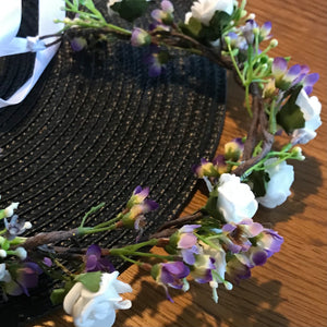 a flower crown of white and lilac artificial flowers